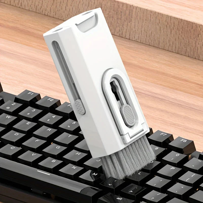 Keyboard Cleaner Brush Dust Removal Kit - Soft bristle brush end of the cleaning tool brushing debris from between black keyboard keys