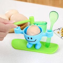 Egg Cup Holder - Blue character stand holding a cracked brown boiled egg, with a hand holding the attached mallet to tap the egg shell