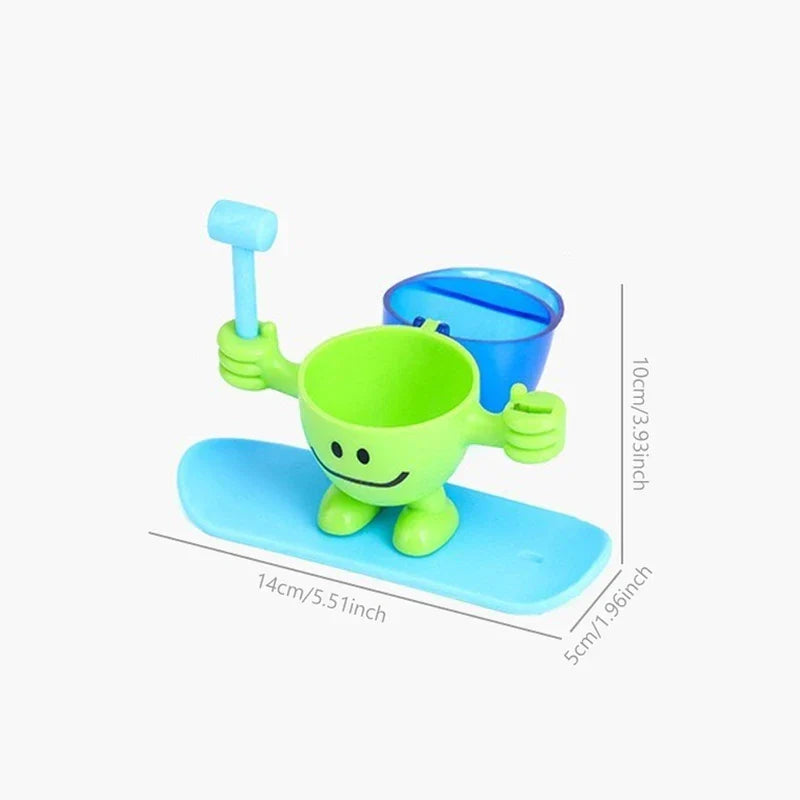 Egg Cup Holder - Green novelty egg cup figurine on a blue base, with attached small hammer and spoon, plus separate blue cup, showing dimension measurements.