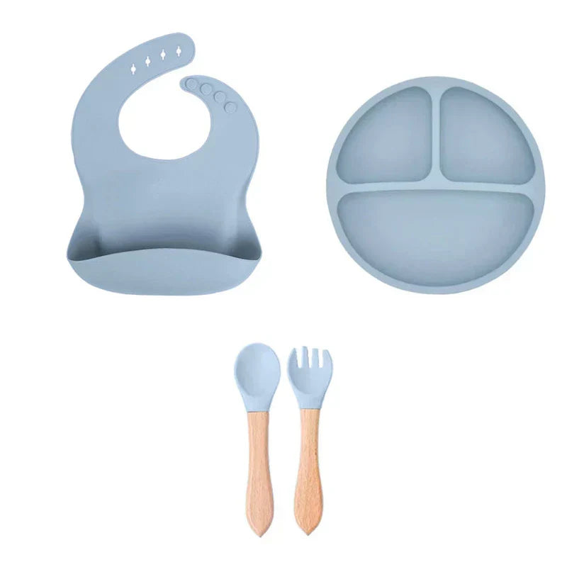 Cutlery Set - Adjustable bib, divided plate, and wood-handled spoon and fork arranged on white background