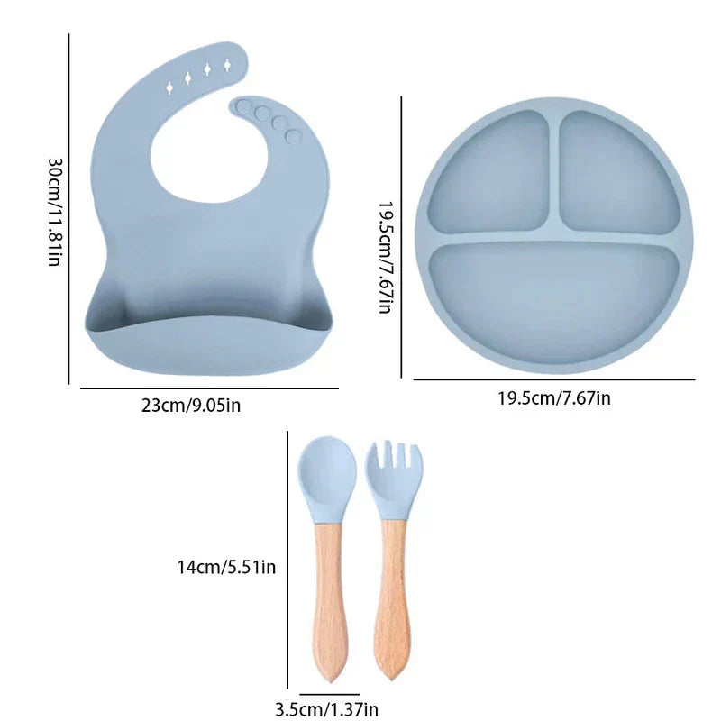 Cutlery Set - A four-piece light blue silicone baby feeding set (bib, divided plate, spoon, fork) with dimension markings in cm and inches