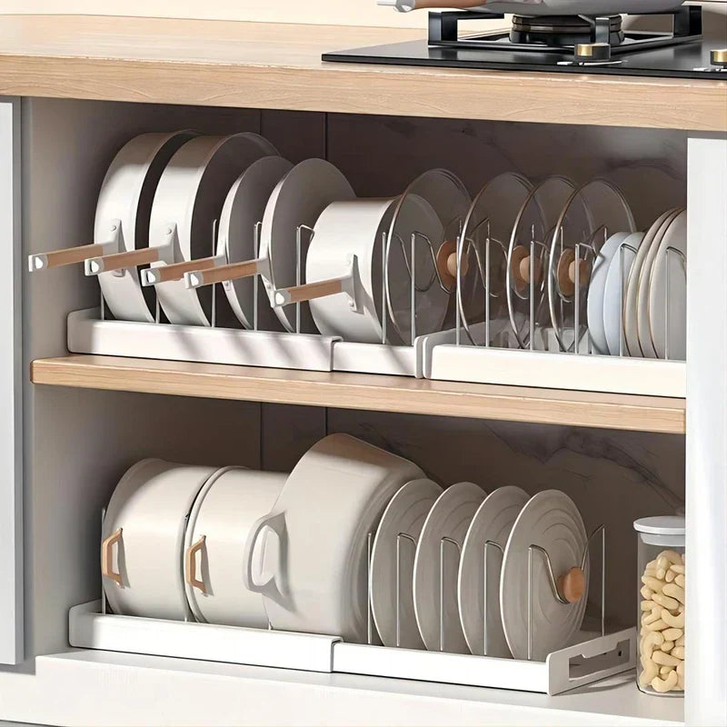 Kitchen Storage Rack - Extendable cabinet pan and dish organizer rack holding upright cookware, plates and pot lids inside a kitchen cabinet shelf