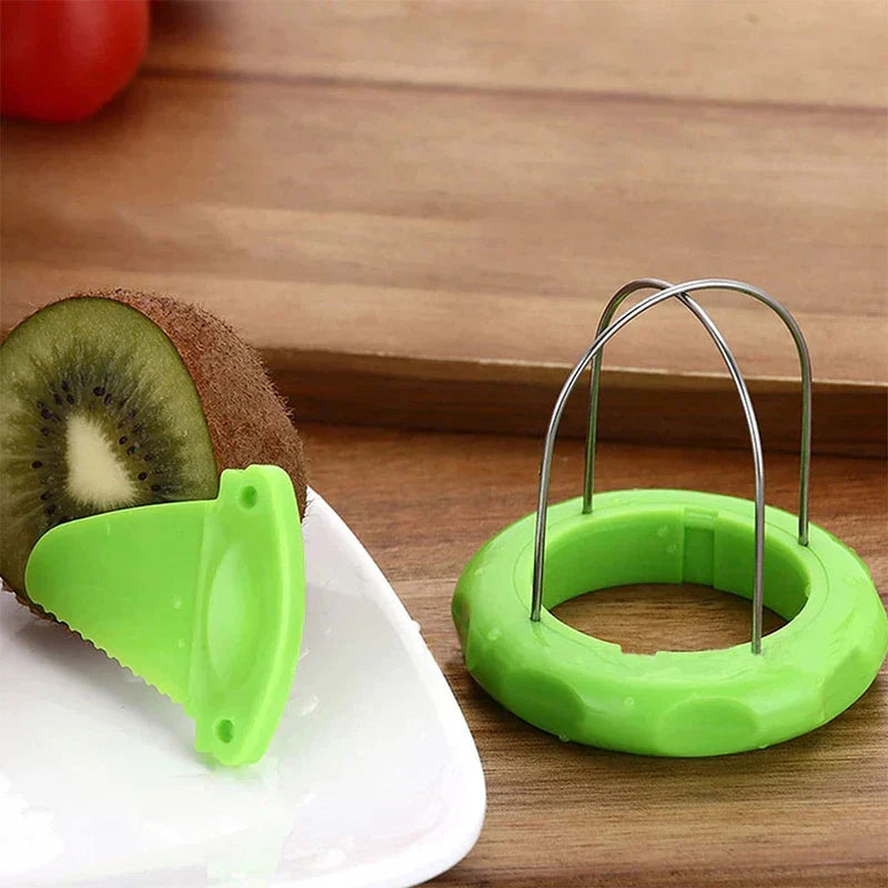 Kiwi Cutter Peeler Slicer Tool - Detachable serrated plastic peeling blade resting against a halved kiwi, with the gadget base placed on a wooden countertop