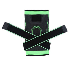 Compression Sleeve - Black and green knee brace laid flat, with two criss-cross strap extensions and a green circular knee contour pattern.