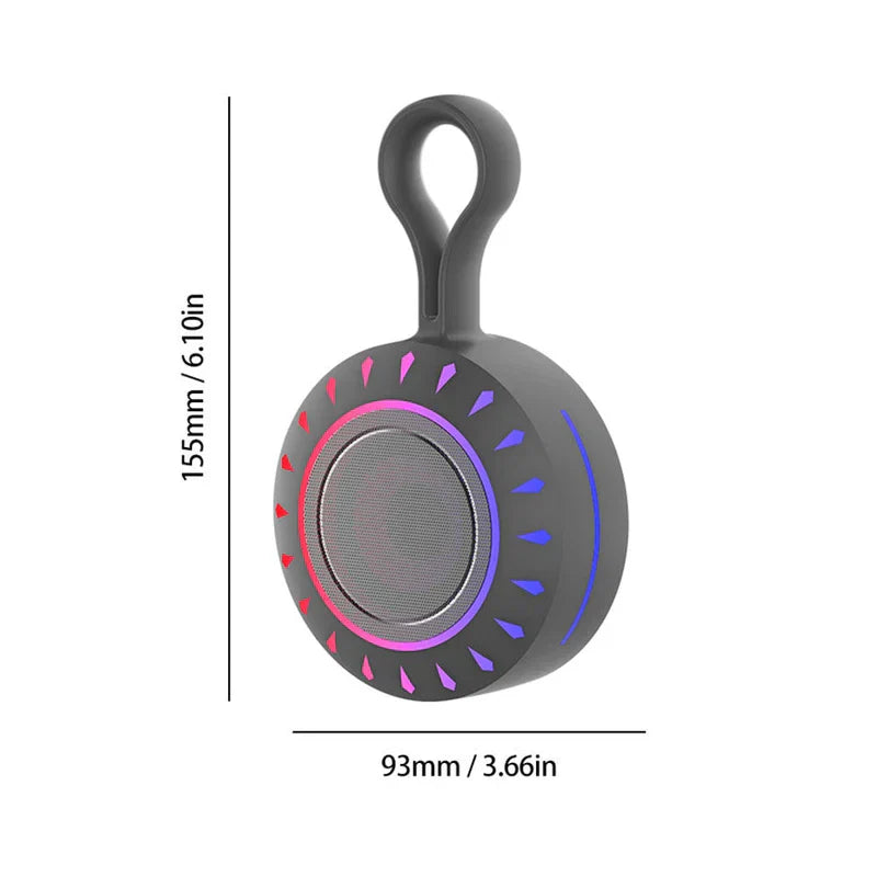 Portable Bluetooth Speaker - Charcoal gray portable speaker with integrated top loop, circular front, gradient pink-to-purple ring, red-to-blue accent marks, dimension lines showing size
