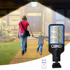 Remote Control - Outdoor light fixture with blue bezel shown illuminating a residential front entry walkway