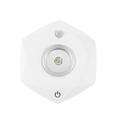 Led Tap Puck Light - Front view of white geometric faceted single light unit with power button and sensor