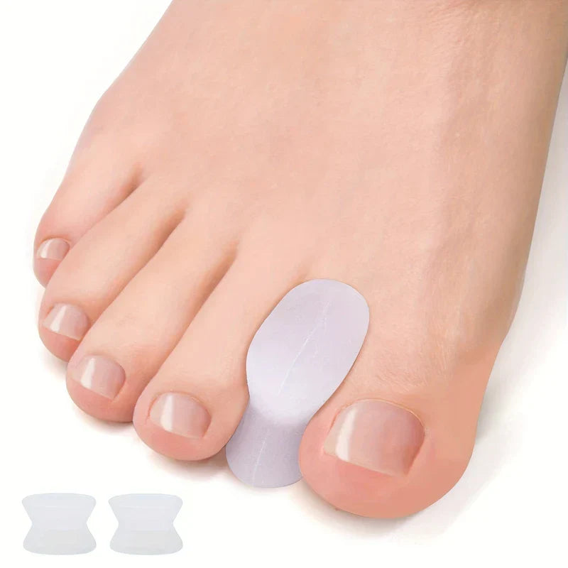 Toe Separators - Clear spacer positioned between big toe and adjacent toe, with two loose spacers shown in the lower corner