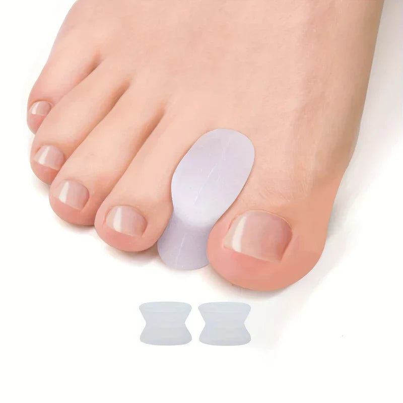 Toe Separators - Silicone toe separator positioned between two toes on a foot, with two additional separators shown below