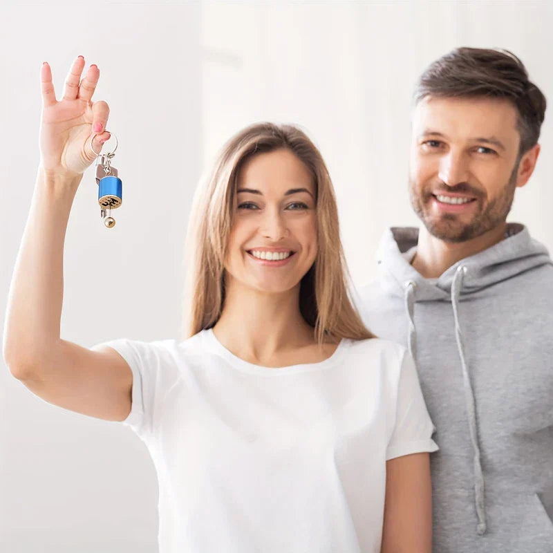 Leather Keychain - Smiling couple, woman holds up blue gear shift keychain