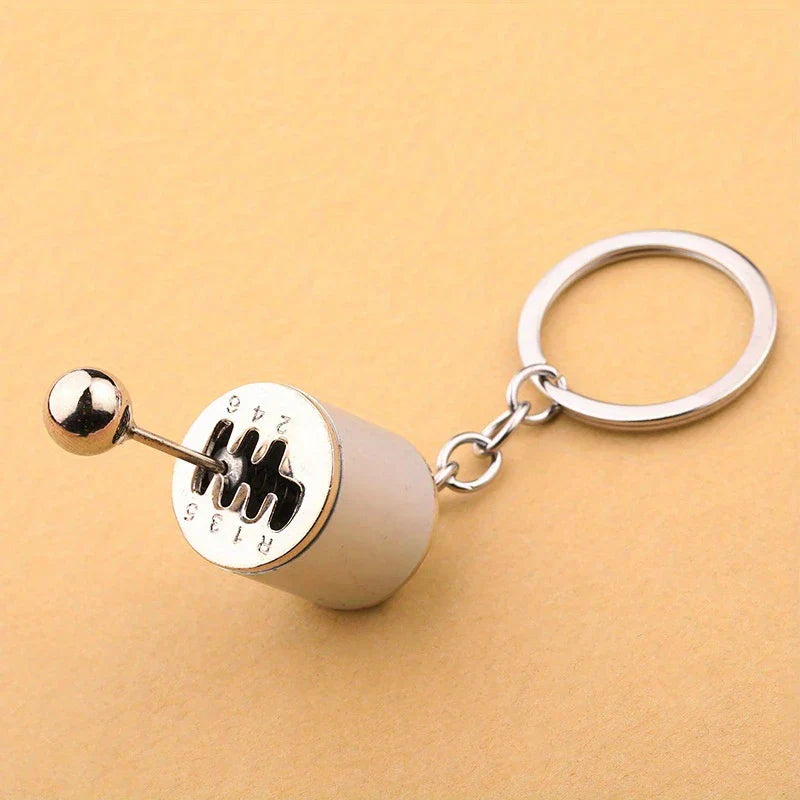 Leather Keychain - Close-up of a miniature manual gear shift keychain against a light tan background