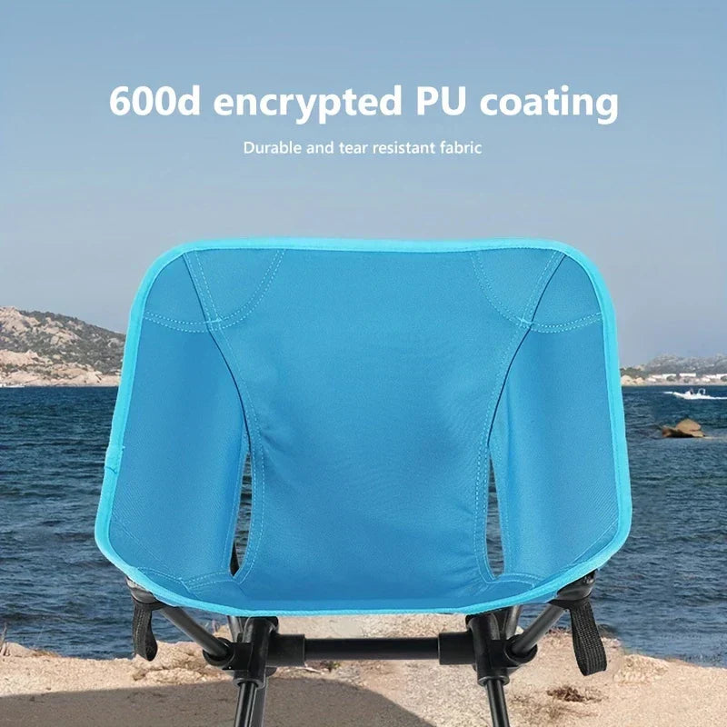 Folding Camping Chair - Back view of bright blue chair positioned on a sandy beach shoreline