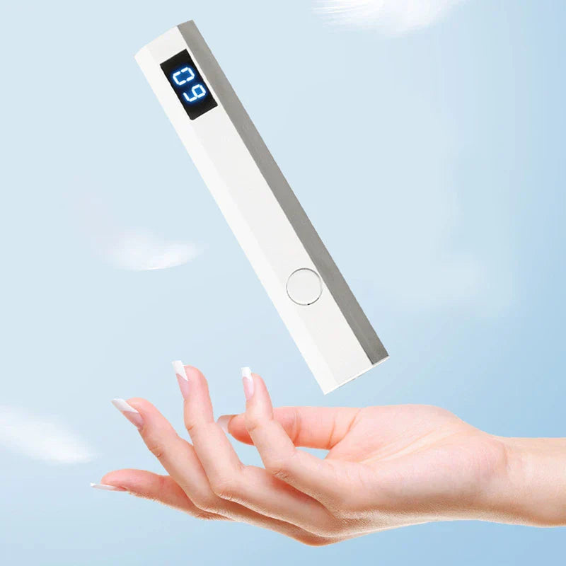 Nail Wand - White rectangular handheld device with a digital display showing '09' floating above a manicured hand against a light blue sky
