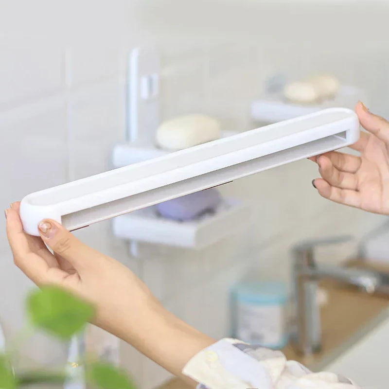 Wall Mount Rack - Two hands holding the white wall-mounted storage organizer, showing its open slot