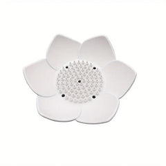 Soap Dish Holder - A white flower-shaped object with raised central bumps and six drainage holes.