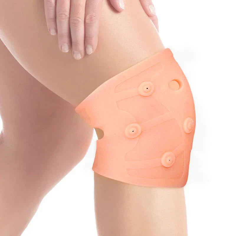 Knee Brace Compression Sleeve - Close-up of a person’s knee, wearing a peach silicone magnetic knee brace, with a hand resting on their thigh