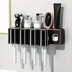 Magnetic Toothbrush Holder Set - Wall-mounted holder with four inverted cups, toothbrush slots, top shelf holding a razor, two pump bottles, a hairbrush, and a toothpaste tube, built-in toothpaste dispenser