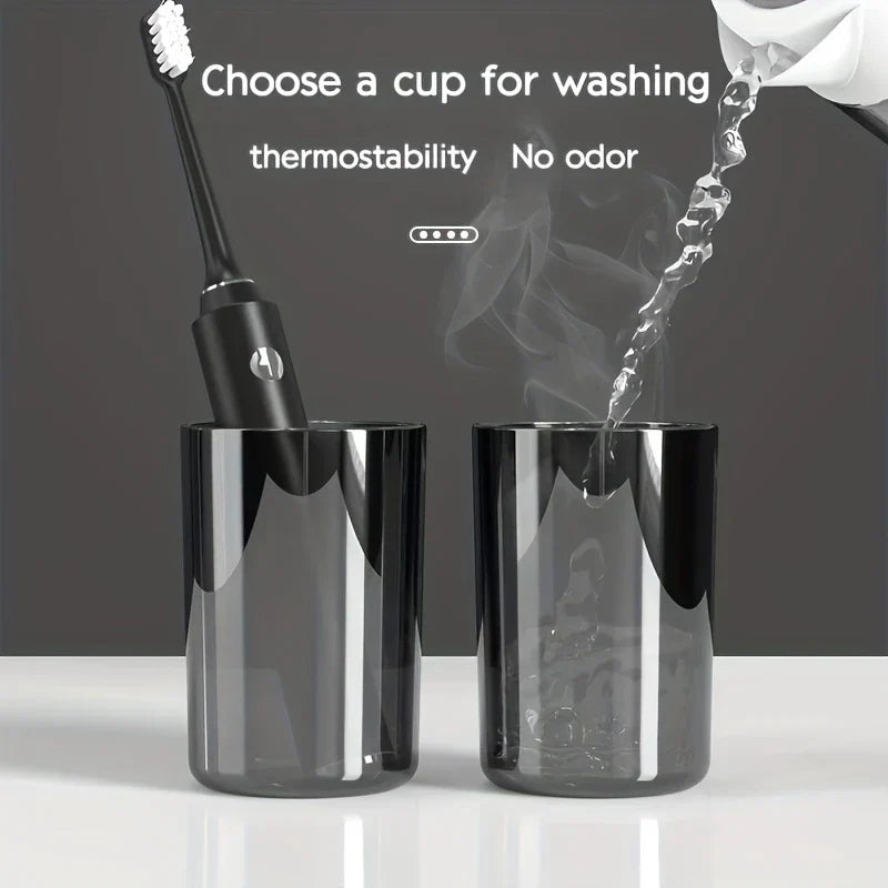 Magnetic Toothbrush Holder Set - Two translucent gray cups on a white countertop; one holds a black electric toothbrush, water pours into the other with steam rising, text above.