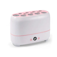 Makeup Brush Cleaner - Slightly angled front view of white and pink countertop device showing control buttons and top slot arrangement