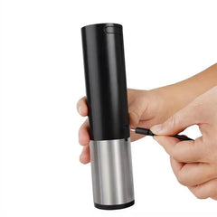 Manual Beer Bottle Cap Opener Tool - Hands plugging a USB charging cable into the side of the cylindrical bar tool