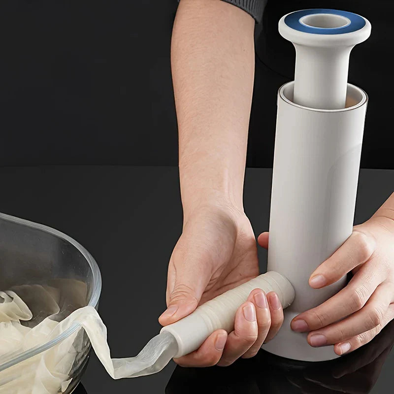 Manual Meat Grinder - Hands sliding sausage casing onto the stuffer's nozzle, with a bowl of soaking casings nearby