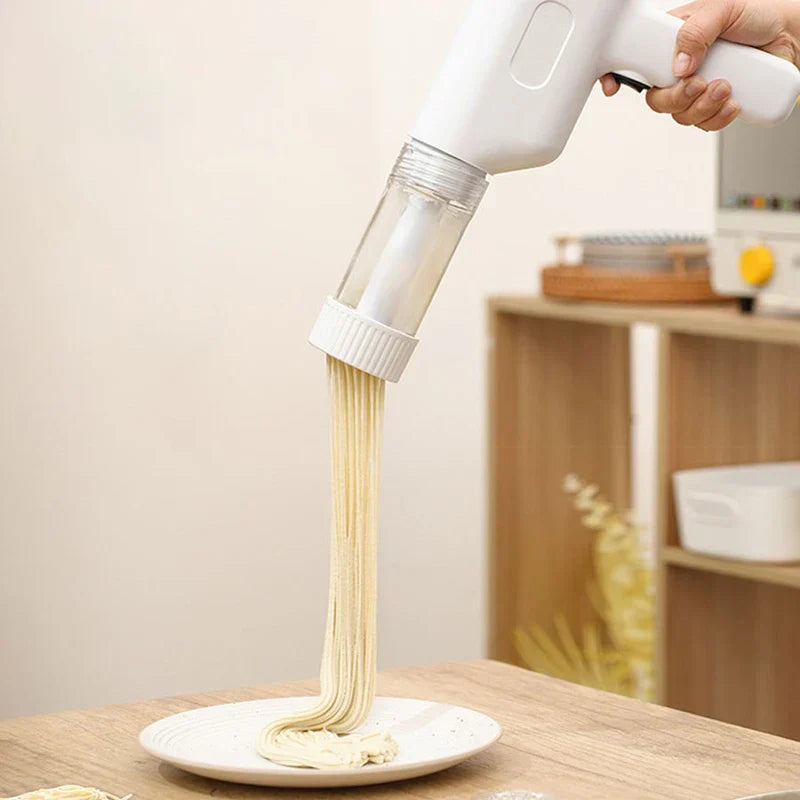 Manual Pasta Maker - Hand holding a white handheld noodle maker, pressing fresh noodles onto a white plate on a wooden table