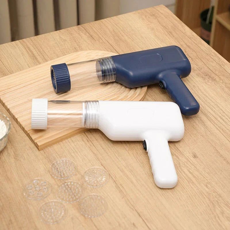 Manual Pasta Maker - White and navy handheld cordless noodle makers placed on a wood surface with interchangeable noodle shaping discs.