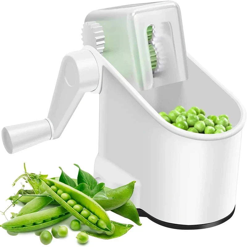 Manual Pea Sheller - White hand-crank shelling device with collection bin holding shelled peas, fresh whole and opened pea pods placed in front
