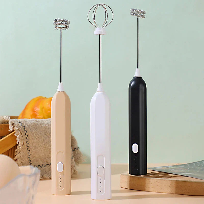 Whisk Mixer - Three handheld mixing tools in beige, white, and black, displayed upright with two different whisk head styles