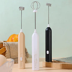Whisk Mixer - Three handheld mixing tools in beige, white, and black, displayed upright with two different whisk head styles