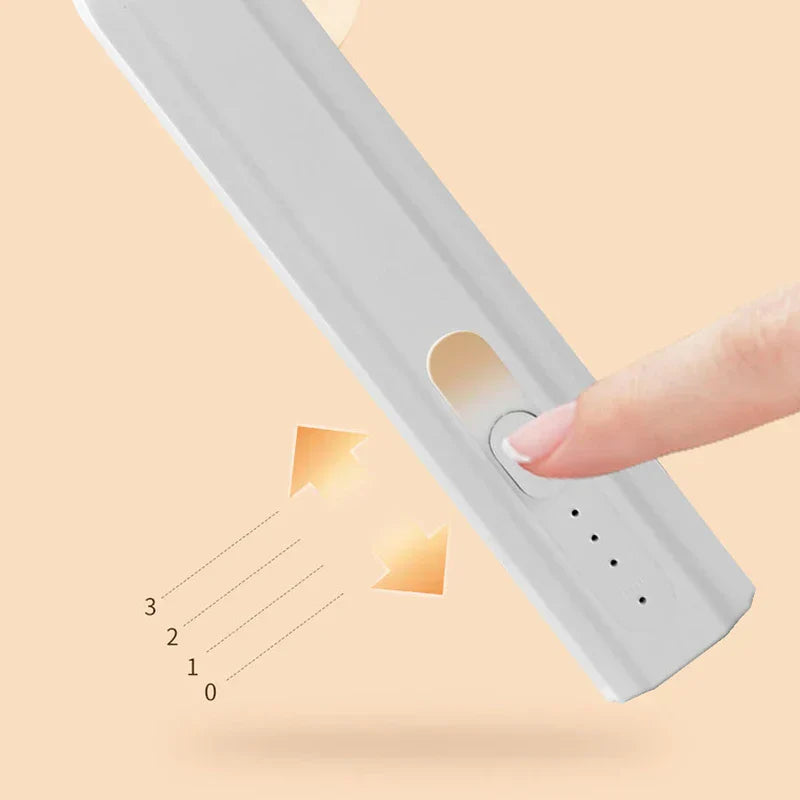 Whisk Mixer - Close-up of a finger pressing the sliding power/speed switch on the side of a white handheld device, with 0-3 speed markers indicated