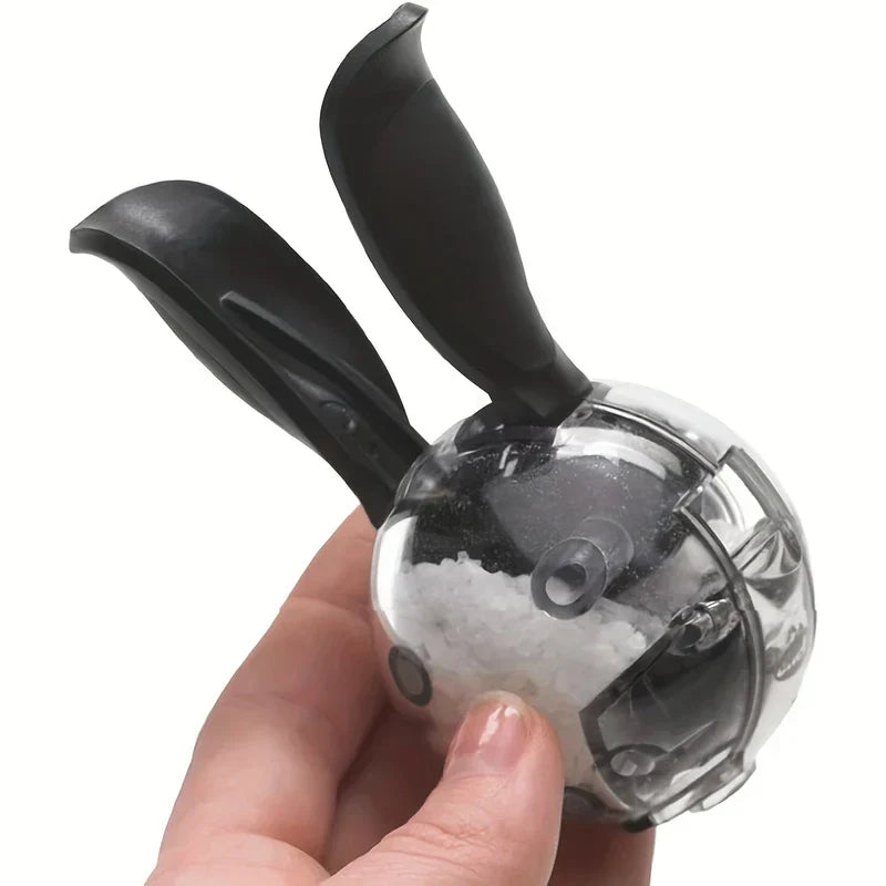Pepper Grinder - Hand holding the clear manual mill filled with coarse white salt