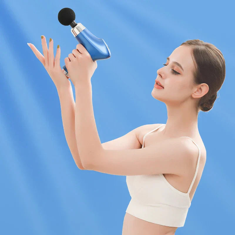 Magnetic Heads - Woman holding blue massage gun up with both hands against a solid blue background.