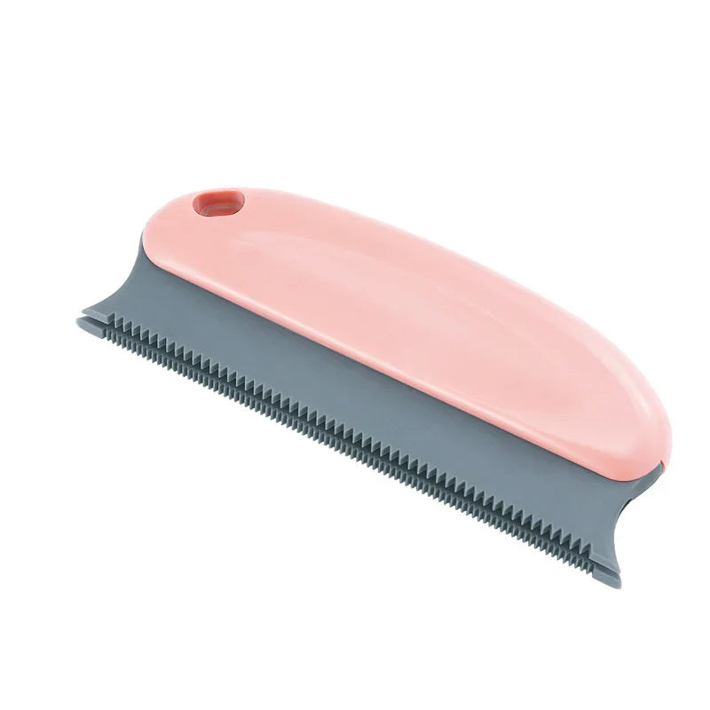 Dusting Brush - Pink handled cleaning tool with gray serrated edge and hanging hole