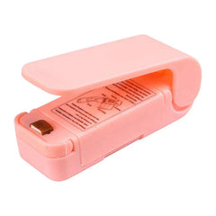 Heat Sealer - Light pink handheld sealing tool shown open, with printed usage instructions visible on the inner body