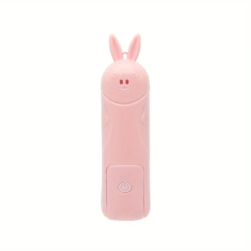 Mini Fan - Closed pink bunny-themed folding portable fan against a plain white background