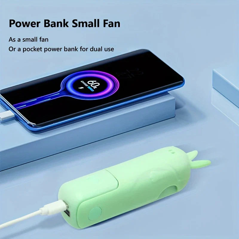 Mini Fan - Light green folded unit connected via cable charging a smartphone