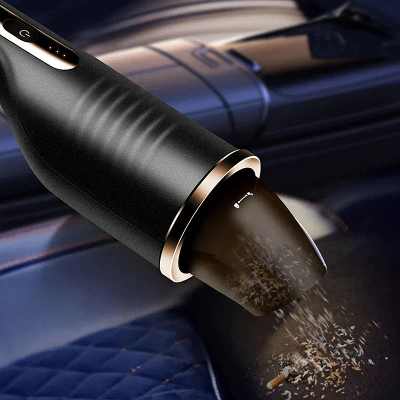 Mini Vacuum - Close-up of vacuum nozzle picking up small debris from a quilted dark blue car seat
