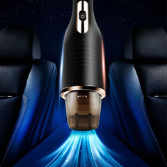 Mini Vacuum - Front view of vacuum positioned between two dark car seats, with visual representation of suction airflow from the dust cup