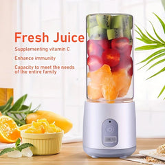 White portable blender filled with sliced kiwi, tomato and orange pieces, with prepared fruit and text on a light background