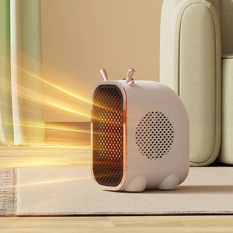 Mini Space Heater - White compact heater sitting on a light rug, blowing warm orange air out its front grille, with a sofa and curtains in the background.