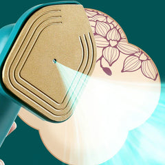 Electric Travel Iron - Close-up of the gold soleplate of a teal handheld iron emitting a fine steam spray