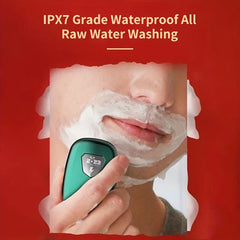 Portable Electric Shaver - Teal shaver held in hand during use with shaving cream, highlighting IPX7 waterproof washable design