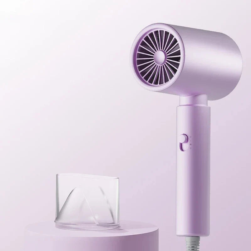 Light purple handheld hair dryer standing upright, with a clear plastic concentrator nozzle placed on a surface beside it.