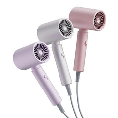 Hair Dryer - Three compact handheld hair dryers in light purple, white, and pink, angled to display their front grilles and handle switches.