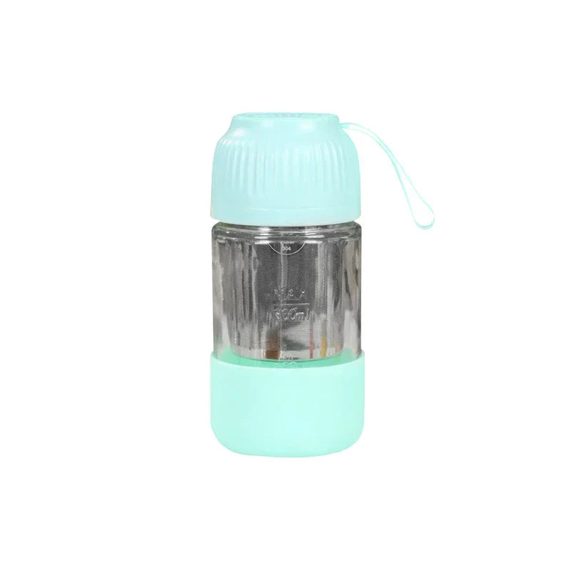 Mini portable juicer blender cup personal with fresh fruit on a kitchen counter