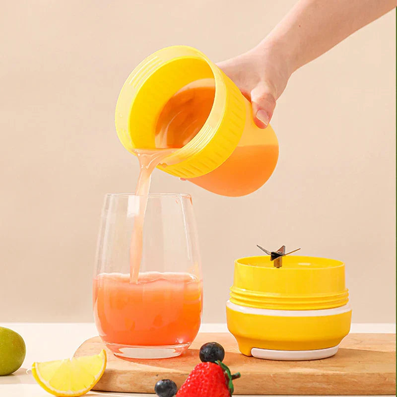 Portable Juicer Blender - Hand pouring orange-pink juice from a yellow cup into a glass, with a blade component and fruit nearby