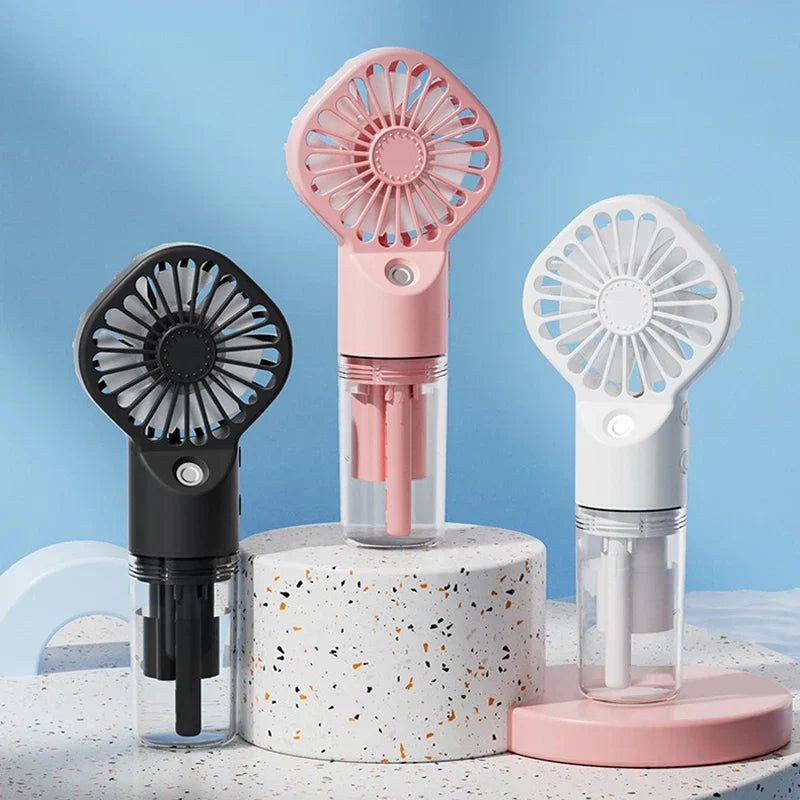 Usb Fan - Three portable handheld fans in black, pink, and white displayed on stands against a blue background