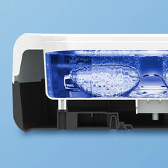 Ultrasonic Jewelry Cleaner - Cutaway view of cleaning chamber filled with bubbling water holding a pair of eyeglasses during operation