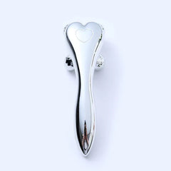Compact face slimming massager on a clean surface